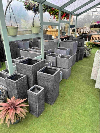 Selection of dark grey ceramic pots suitable for balcony gardening