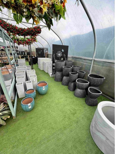 Selection of dark grey ceramic and glazed large troughs, pots and containers suitable for balcony gardening